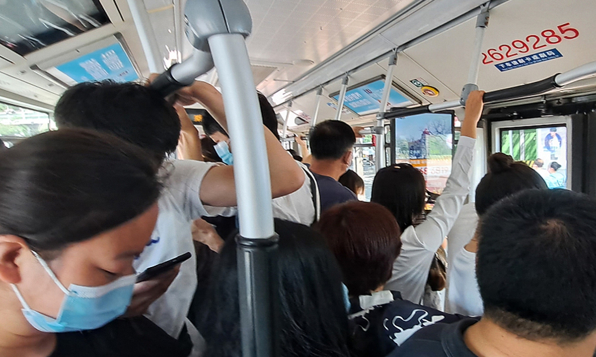 Commuters wear masks on a bus in Beijing  Source: VCG