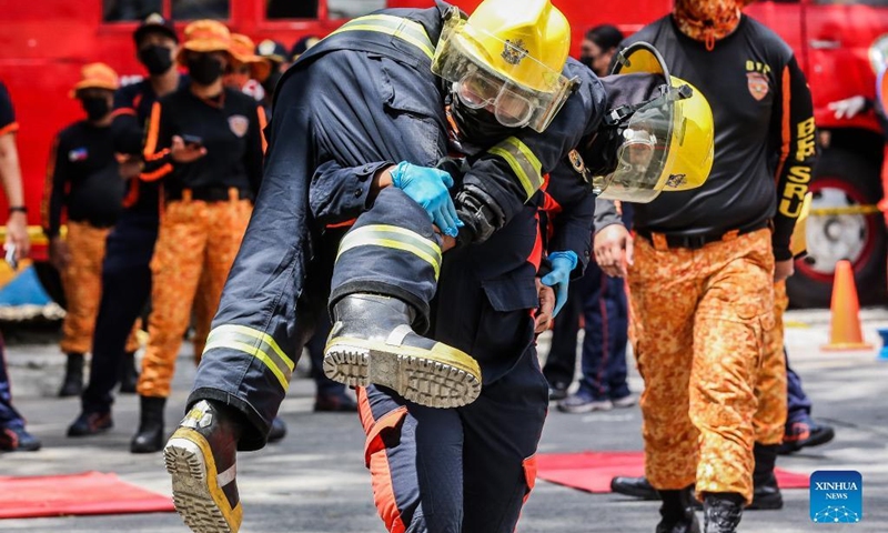 Female firefighters participate in the Women Firefighters Skills Olympics at the Philippine Bureau of Fire Protection-National Capital Region (BFP-NCR) headquarters in Quezon City, the Philippines on March 14, 2022.(Photo: Xinhua)