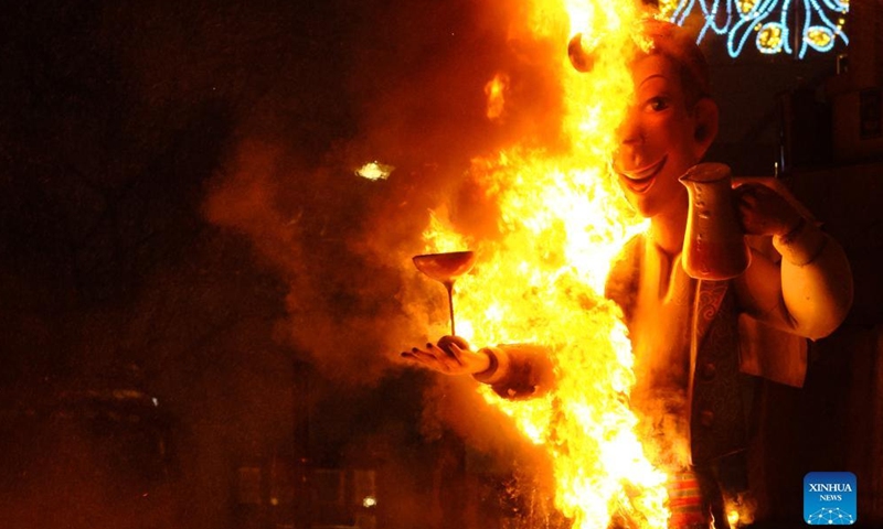 A giant doll is set on fire during the Fallas Festival celebrations in Valencia, Spain, on March 19, 2022.Photo:Xinhua