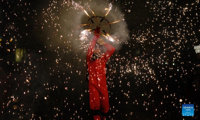 A person takes part in a fire parade during the Fallas Festival celebrations in Valencia, Spain, on March 19, 2022.Photo:Xinhua