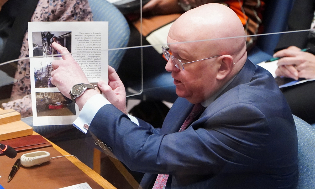 Russia’s Ambassador to the UN Vasily Nebenzya shows pictures during the UN Security Council meeting discussing US biological warfare labs in Ukraine, on March 11, 2022. Photo: IC