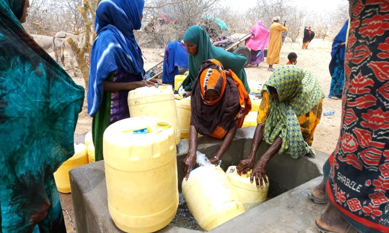 Women fetch water at a borehole in Garissa County, Kenya, Nov. 20, 2021.(Photo: Xinhua)