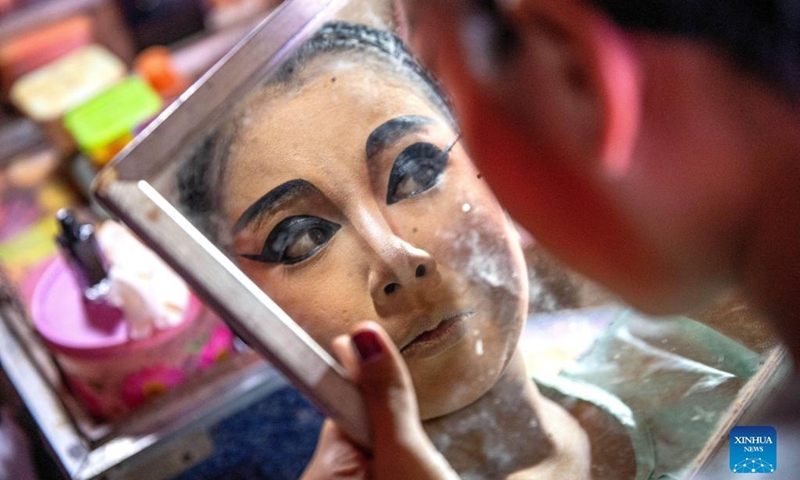 An actress makes up at the backstage in Nakhon Sawan, Thailand, March 24, 2022. Chinese migrants brought the Chaozhou Opera with them to Thailand more than a hundred years ago.(Photo: Xinhua)