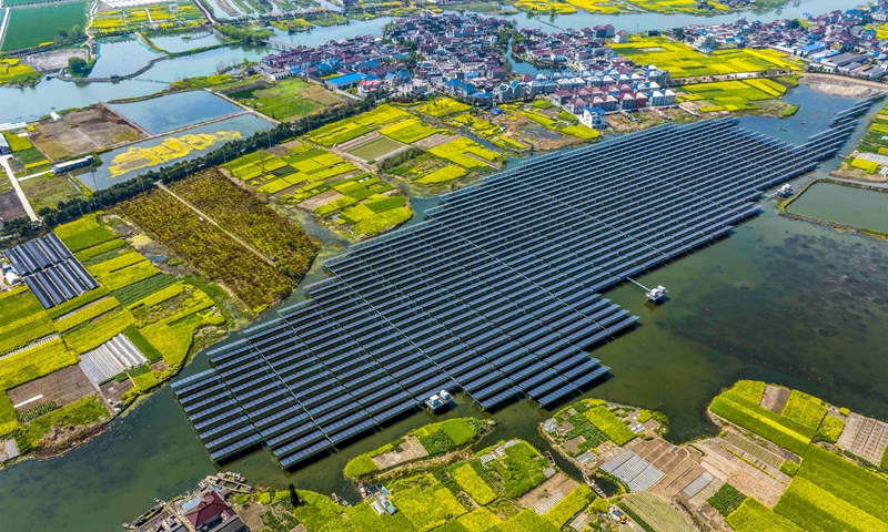 An aerial photo shows photovoltaic panels placed on a fishpond in Yuxi town, East China's Jiangsu Province, on April 6, 2022. Solar power generation, fishery and rape flower planting are realized simultaneously in the town. In recent years, Taizhou, where Yuxi is located, has taken advantage of its dense water networks to build photovoltaic power generation projects on fishponds and mudflats. Photo: VCG