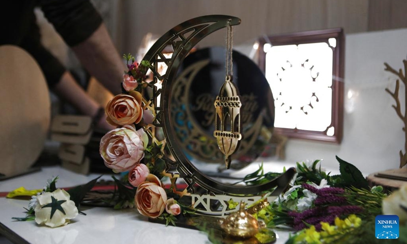 A man makes wooden decorations at a family workshop ahead of the Islamic holy month of Ramadan, in the West Bank city of Hebron, on March 29, 2022.(Photo: Xinhua)