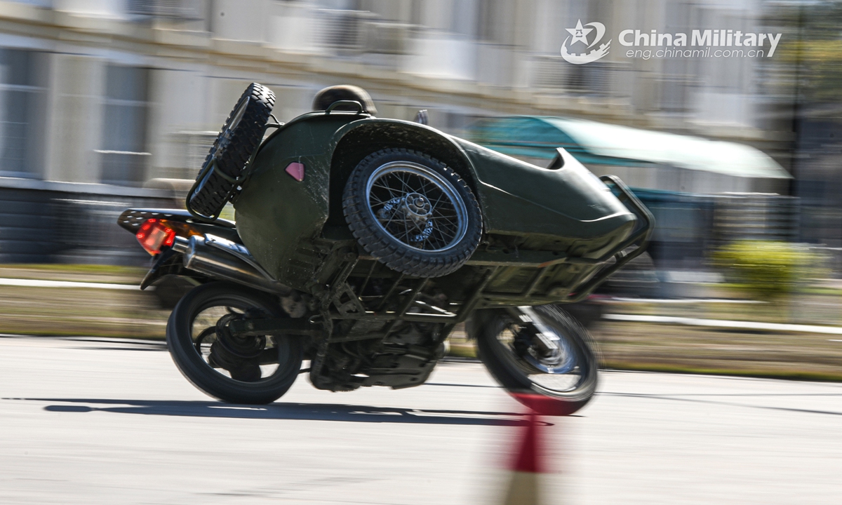 A soldier assigned to a commanding communication company of a brigade under the PLA 73rd Group Army drives a motorbike at high speed on a bend during the driving skill training on March 8, 2022.Photo:China Military