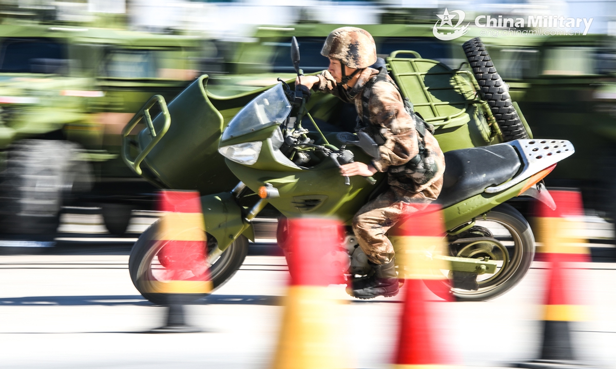 A soldier assigned to a commanding communication company of a brigade under the PLA 73rd Group Army drives a motorbike at high speed on a bend during the driving skill training on March 8, 2022.Photo:China Military