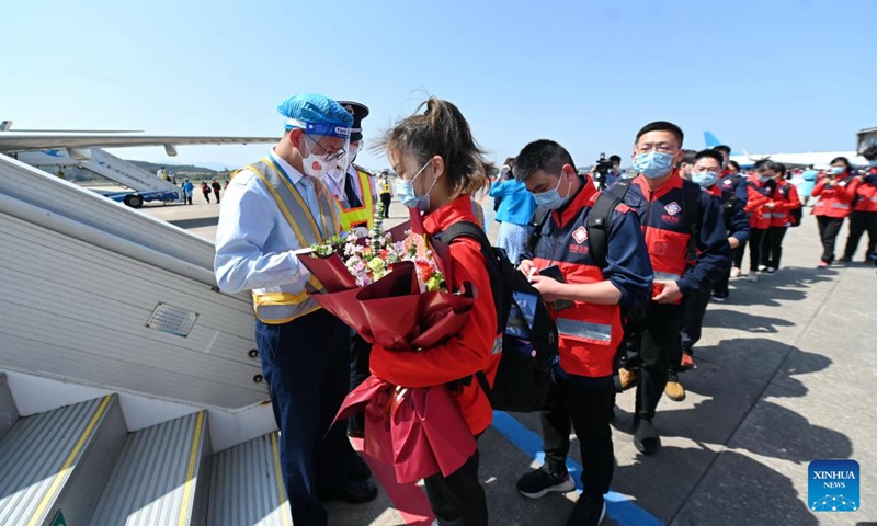 Medics board an airplane for east China's Shanghai at Changle Airport in Fuzhou, southeast China's Fujian Province, April 7, 2022. A total of 1,730 supportive medics from Fujian Province set off on Thursday from Fuzhou and Xiamen to Shanghai to aid in the battle against the resurging COVID-19 epidemic.Photo:Xinhua