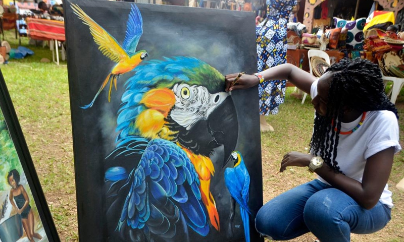 A visitor views paintings during the Uganda Arts and Cultural Crafts Expo in Kampala, Uganda, April 7, 2022. The expo was held at the Uganda National Cultural Center (UNCC) Gardens from April 7 to 10.Photo:Xinhua