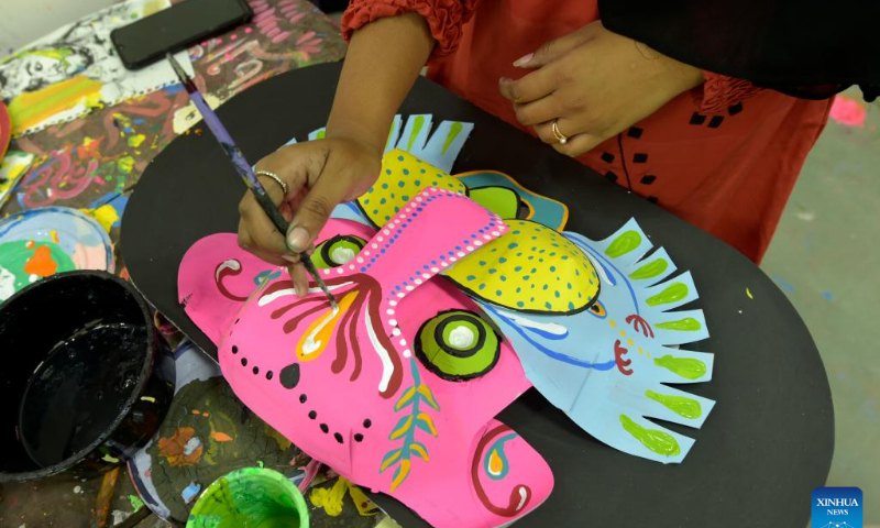 A student paints traditional paper works for the Bengali New Year in Dhaka, Bangladesh, April 10, 2022. The Bangla New Year is usually celebrated amid festivities every year on April 14. Photo: Xinhua