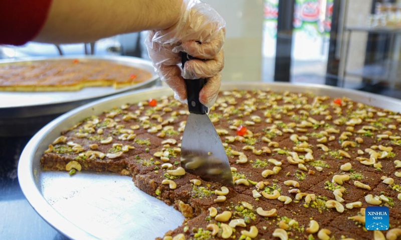 Staff members prepare traditional sweets during holy month of Ramadan ...