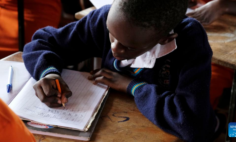 Charles Bwebale writes Chinese characters during a lesson at Entebbe Comprehensive Secondary School in Wakiso, Uganda, April 5, 2022. Photo: Xinhua