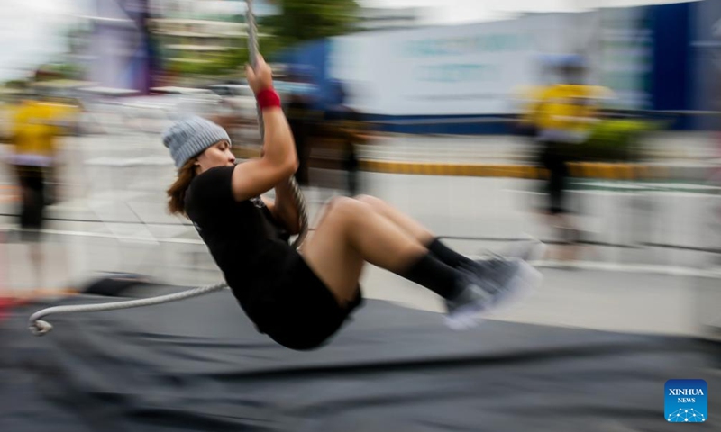 A contestant participates in the Philippine Obstacle Course Racing 100m (OCR 100m) competition in Pasig City, the Philippines on April 9, 2022.Photo:Xinhua