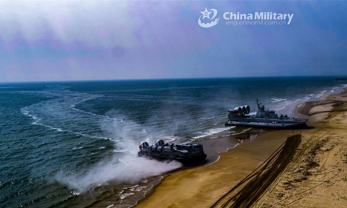 An amphibious infantry fighting vehicle rolls out of a naval air cushioned landing craft during a beach-landing operation jointly conducted by the Marine Corps and a naval landing ship group under the PLA Southern Theater Command on March 22, 2022. (eng.chinamil.com.cn/Photo by Li Jia)