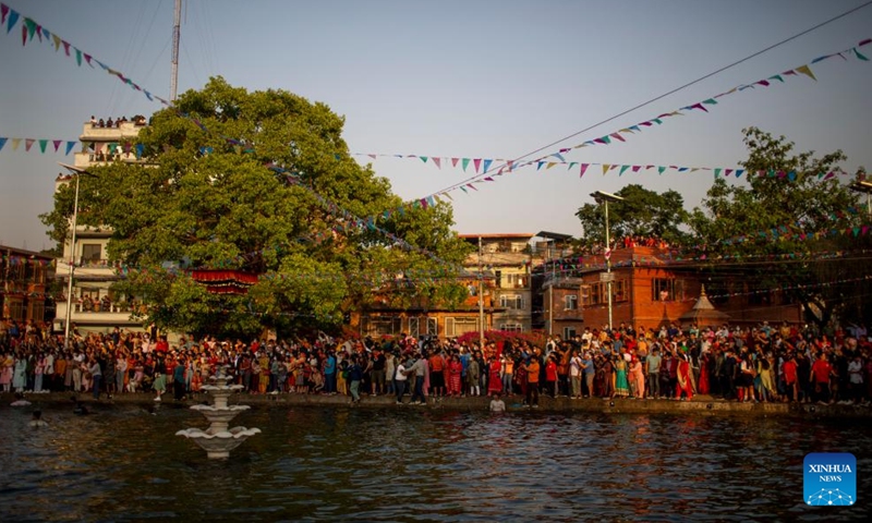 Local people carry the chariot of Tundaldevi on their shoulders and search for the lost jewellery during the traditional Gahana Khojne Jatra festival in Gahana Pokhari (Jewel-Pond) in Kathmandu, Nepal, April 17, 2022.Photo:Xinhua