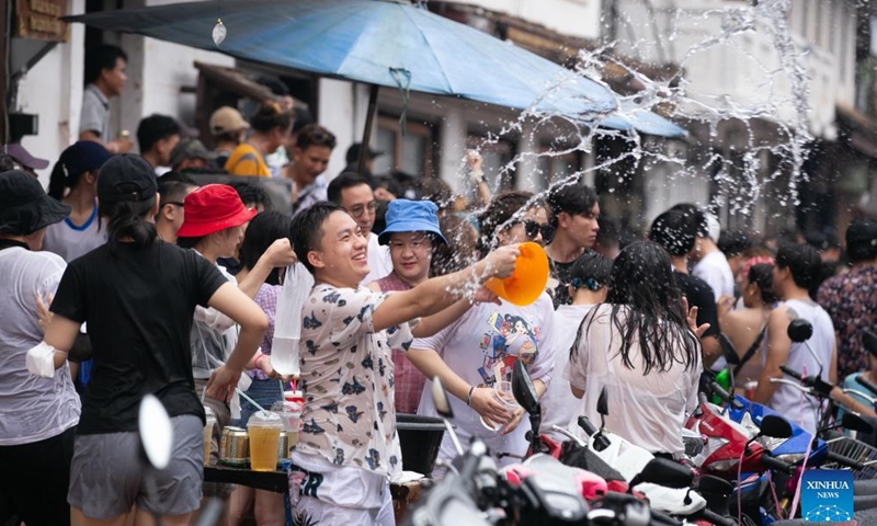 People splash water to each other to celebrate the Songkran Festival, or the Lao New Year, in Luang Prabang, Laos, April 16, 2022. Laos celebrated Songkran from April 14 to 16.Photo:Xinhua