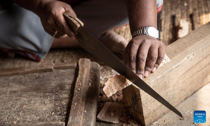 A man works on wood carving in Bungamati, Lalitpur, Nepal, April 18, 2022.(Photo: Xinhua)