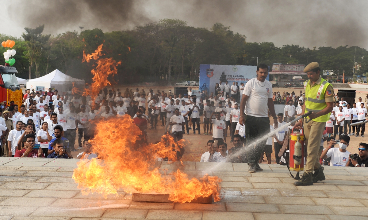 Fire department personnel take part in a safety drill on the occasion of their 