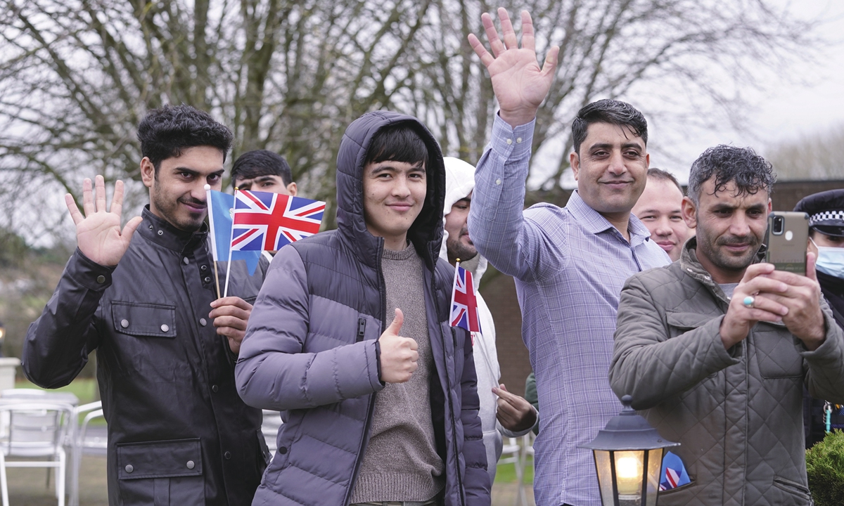 Refugees wave after Britain's Prince William (not in picture) meeting with refugees evacuated from Afghanistan in Leeds, the UK on November 30, 2021.?Photo: IC