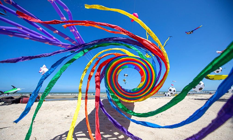 Kites hover above the Cha-am Beach in Phetchaburi, Thailand, on April 23, 2022.Photo:Xinhua