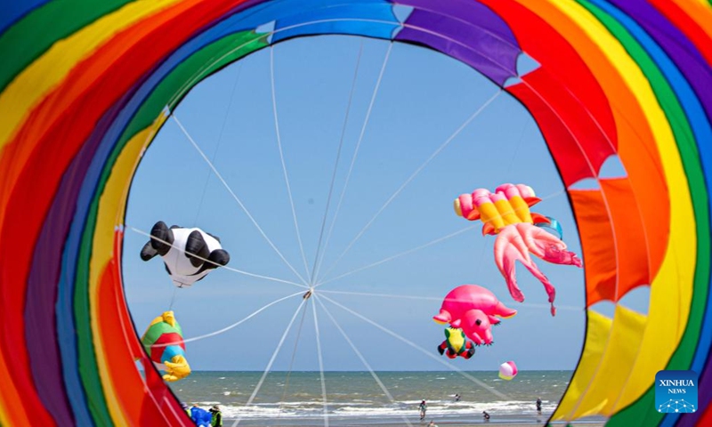 Kites hover above the Cha-am Beach in Phetchaburi, Thailand, on April 23, 2022.Photo:Xinhua