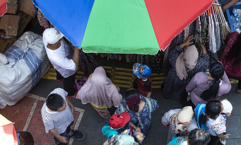 People shop for new clothes ahead of Eid al-Fitr at the Tanah Abang market, in Jakarta, Indonesia, on April 25, 2022.(Photo: Xinhua)