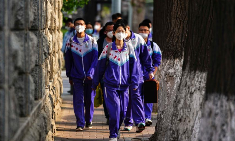 Third-graders of a senior high school take their temperatures to enter the school in Changchun, northeast China's Jilin Province, May 5, 2022. Third-graders of senior high schools in Changchun resumed class on Thursday. (Xinhua)