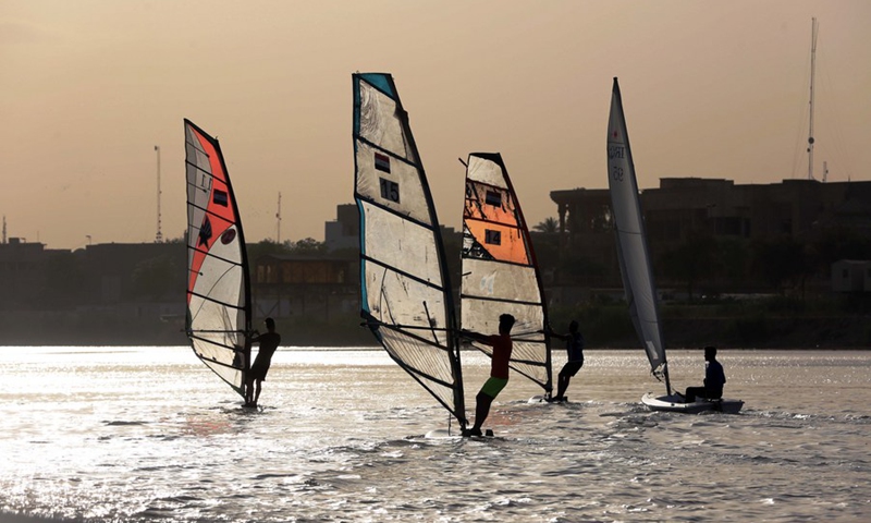 Members of the Iraqi national windsurfing team train in the Tigris River in Baghdad, Iraq, on May 08, 2022.(Photo: Xinhua)