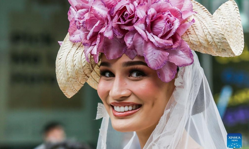 A contestant for the Binibining Pilipinas (Miss Philippines) 2022 participates in the Flores de Mayo (Flowers of May) procession in Quezon City, the Philippines, May 14, 2022. A total of 40 contestants will vie for the Binibining Pilipinas 2022 beauty pageant this year.Photo:Xinhua