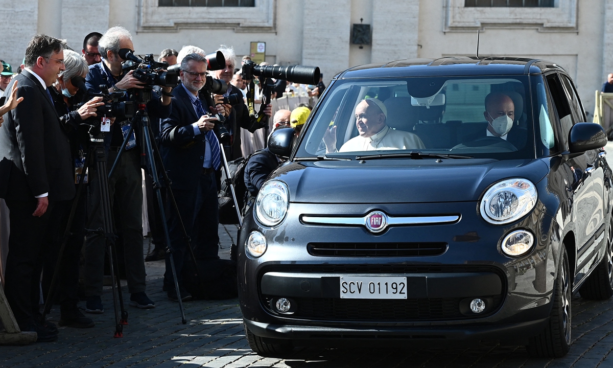 pope francis arrives in a car ahead of a canonization mass 