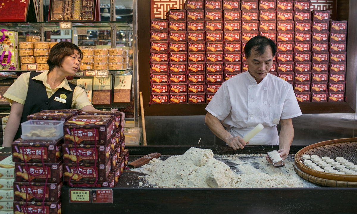 Staff make macaroons in a shop in China's Macao Special Administrative Region. Photo: VCG