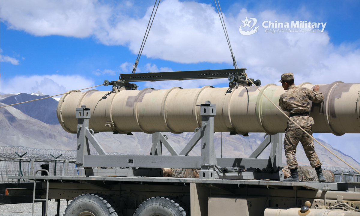 Airmen assigned to a ground-to-air missile brigade with the air force under the PLA Western Theater Command hoist and load an air-defense missile onto a truck during a missile loading operation on May 19, 2022. (eng.chinamil.com.cn/Photo by Tan Zhixuan) 