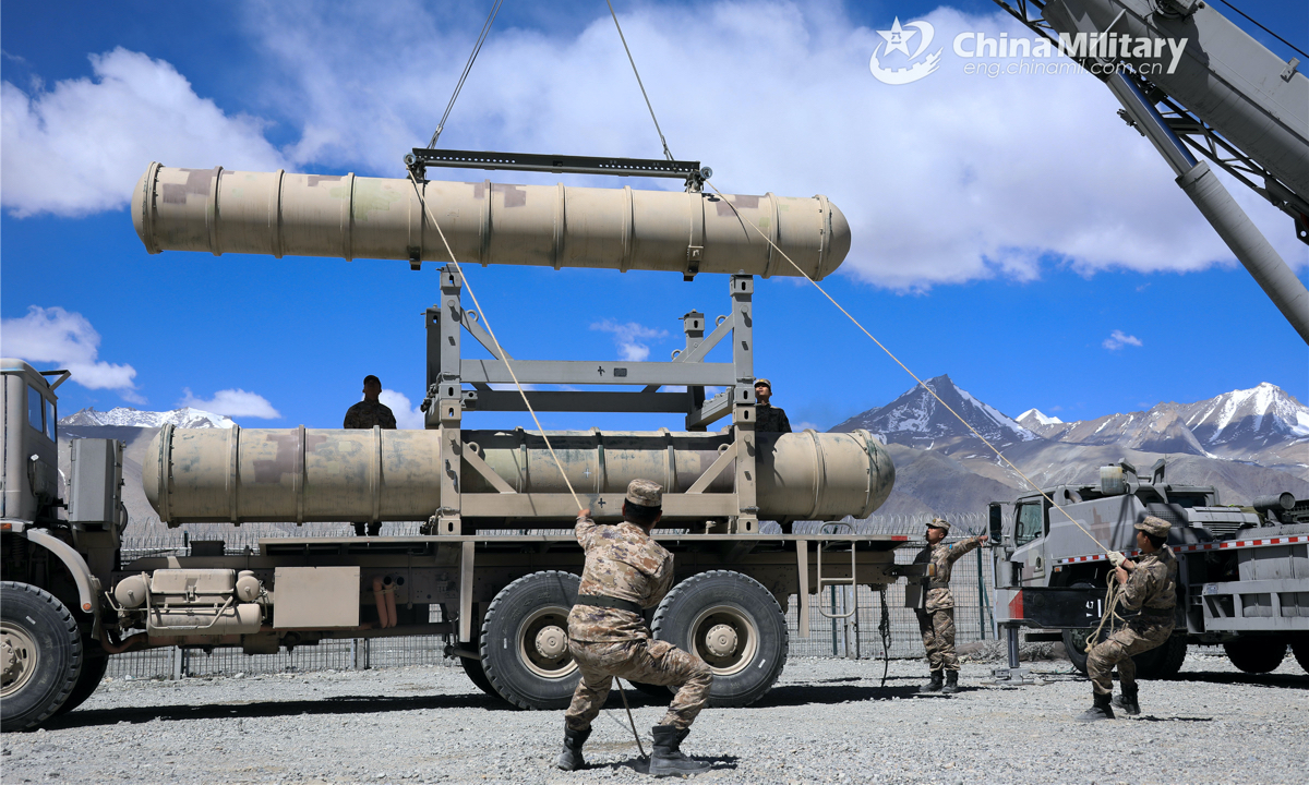 Airmen assigned to a ground-to-air missile brigade with the air force under the PLA Western Theater Command hoist and load an air-defense missile onto a truck during a missile loading operation on May 19, 2022. (eng.chinamil.com.cn/Photo by Tan Zhixuan) 