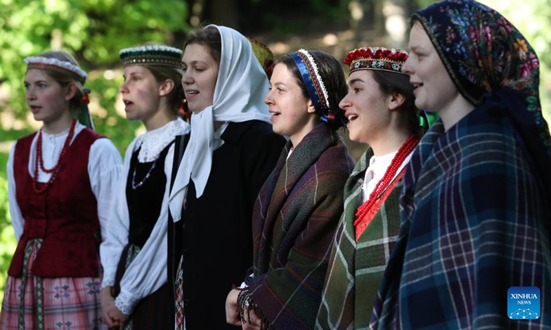 People in traditional costume perform during the 49th International Folklore Festival in Vilnius, Lithuania, on May 27, 2022.Photo:Xinhua