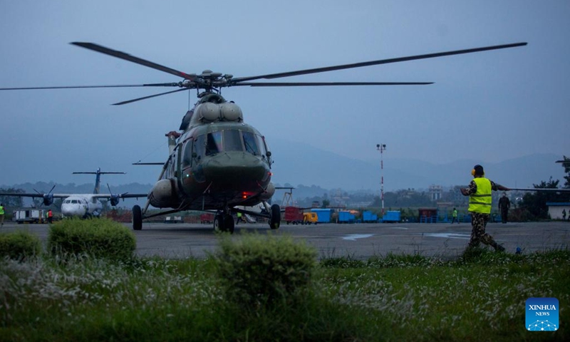 A Nepal Army helicopter carrying bodies of victims of a plane crash lands at the airport in Kathmandu, Nepal, May 30, 2022. Twenty-one bodies have been recovered from the crash site of a Nepali passenger plane in a remote hilly area in Nepal's Mustang district, a local government official said on Monday. Ten bodies have been sent to Kathmandu in a helicopter, the official said. (Photo: Xinhua)