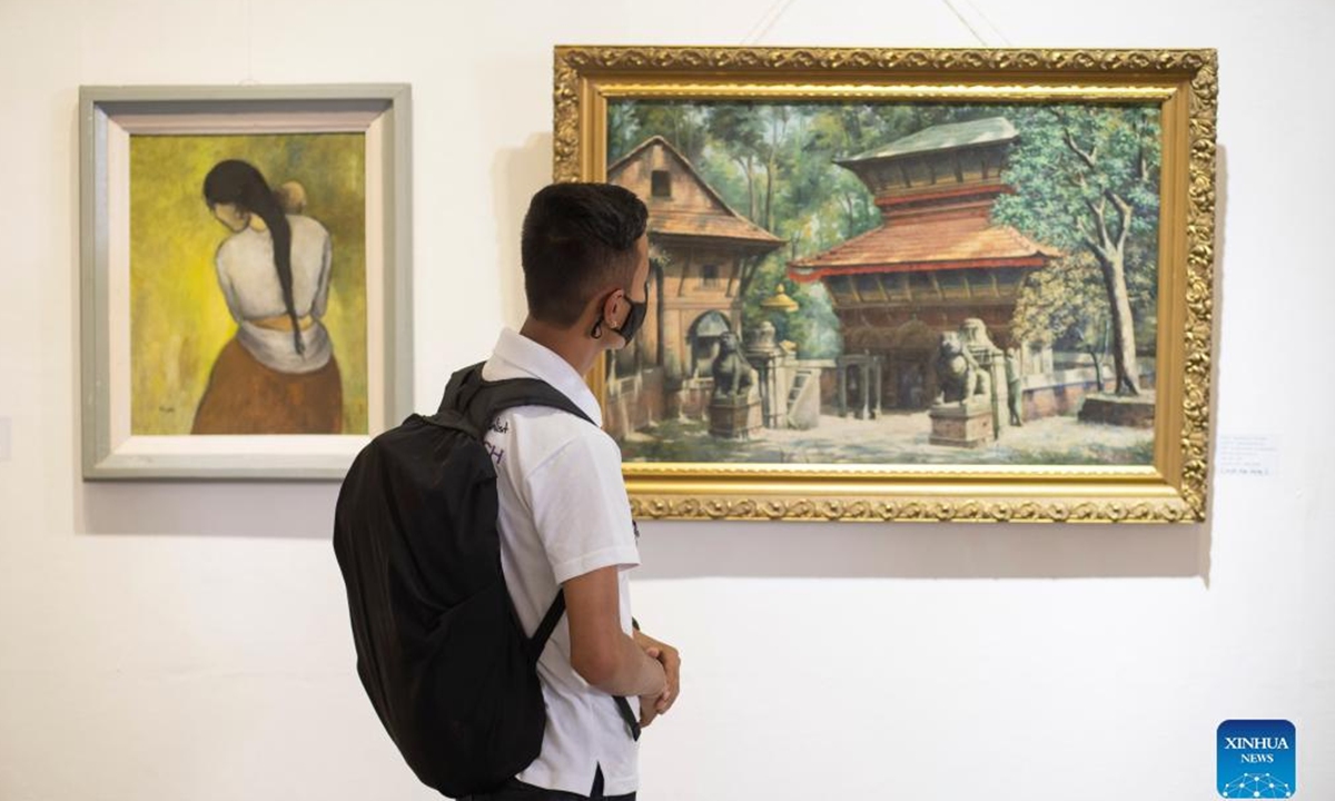 Visitors view an art exhibition dubbed Images of the Pioneers at Nepal Art Council in Kathmandu, Nepal, June 2, 2022. (Photo by Hari Maharjan/Xinhua)