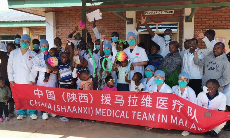 The members of the Chinese Medical Team in Malawi posed with some children at the entrance of the paediatric ward of the Mzuzu Central Hospital in Mzuzu, Malawi, on June 1, 2022.Photo:Xinhua