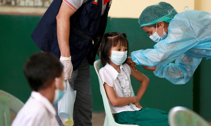 A student receives a dose of COVID-19 vaccine at a school in Yangon, Myanmar, on June 10, 2022.Photo:Xinhua