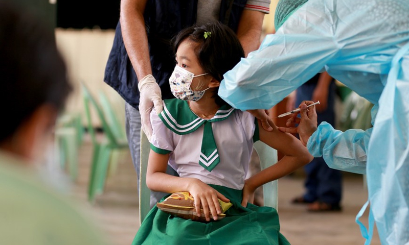 A student receives a dose of COVID-19 vaccine at a school in Yangon, Myanmar, on June 10, 2022.Photo:Xinhua