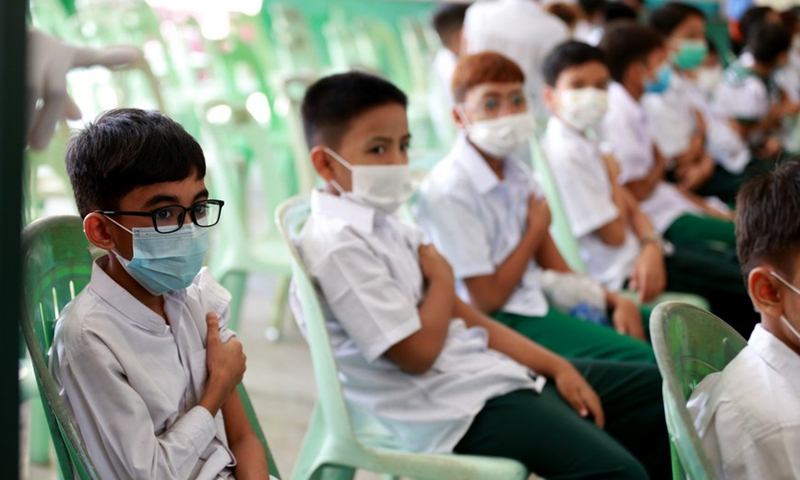 Students rest after receiving COVID-19 vaccines at a school in Yangon, Myanmar, on June 10, 2022.Photo:Xinhua