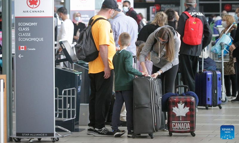 Travelers wait to check in at Vancouver International Airport in Richmond, British Columbia, Canada, on June 14, 2022. The Canadian federal government announced Tuesday that it will suspend vaccination requirements against COVID-19 for domestic and outbound travel, federally regulated transportation sectors and federal government employees as of June 20.(Photo: Xinhua)
