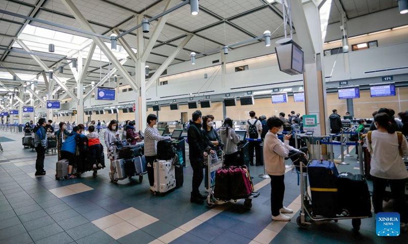 Travelers line up at Vancouver International Airport in Richmond, British Columbia, Canada, on June 14, 2022. The Canadian federal government announced Tuesday that it will suspend vaccination requirements against COVID-19 for domestic and outbound travel, federally regulated transportation sectors and federal government employees as of June 20.(Photo: Xinhua)