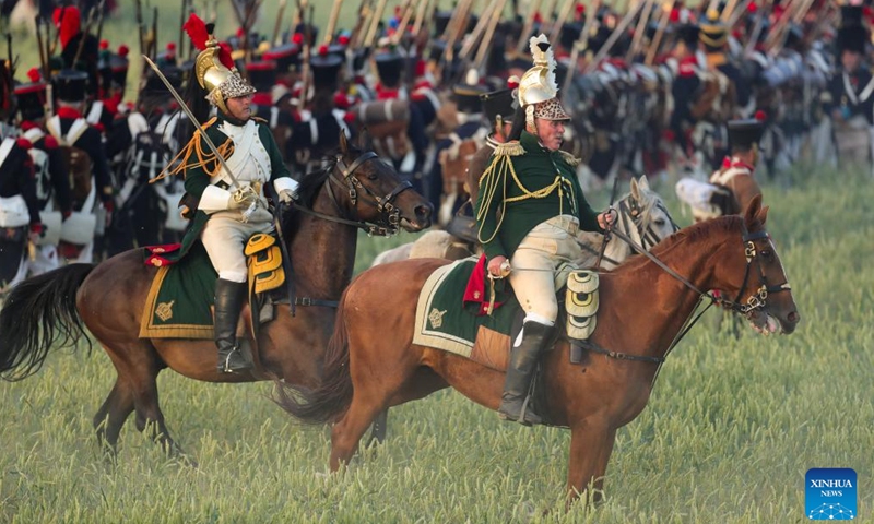 Re-enactors attend the re-enactment of the 1815 Battle of Waterloo in Waterloo, Belgium, June 18, 2022. About 2,000 re-enactors, more than 100 horses as well as over 20 canons participated in the re-enactment, showing the clash of June 18, 1815 between Napoleon and Wellington. The event marked the 207th anniversary of the Battle of Waterloo.Photo:Xinhua