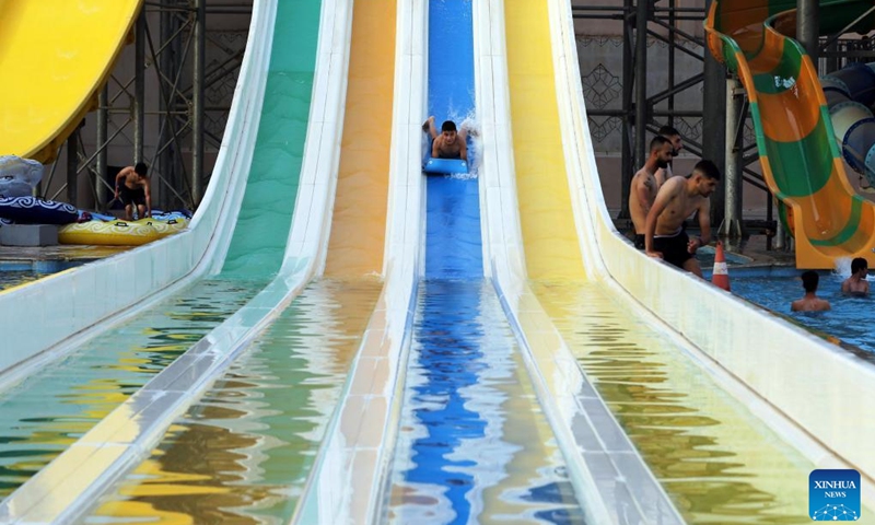 People spend time at a water park during a hot day in Baghdad, Iraq, on June 20, 2022. Iraq witnessed hot weather recently, with the highest temperature soaring to 50 degrees Celsius in some regions of the country.(Photo: Xinhua)