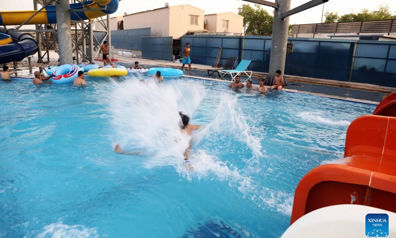 People spend time at a water park during a hot day in Baghdad, Iraq, on June 20, 2022. Iraq witnessed hot weather recently, with the highest temperature soaring to 50 degrees Celsius in some regions of the country.(Photo: Xinhua)