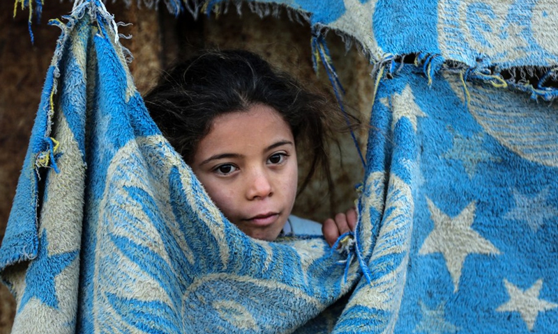 A Palestinian girl is seen outside her house at a refugee camp in the southern Gaza Strip city of Khan Younis, on Jan. 17, 2022.(Photo: Xinhua)