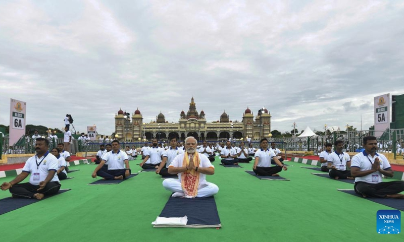 Indian Prime Minister Narendra Modi (front) performs yoga along with people on International Yoga Day at the Mysuru Palace, in Mysuru, India, June 21, 2022.(Photo: Xinhua)