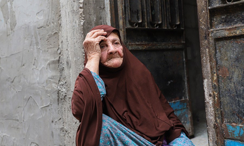 Palestinian refugee woman Fatima Abu Atwan sits outside her house in Khan Younis refugee camp in the southern Gaza Strip on May 14, 2022.(Photo: Xinhua)