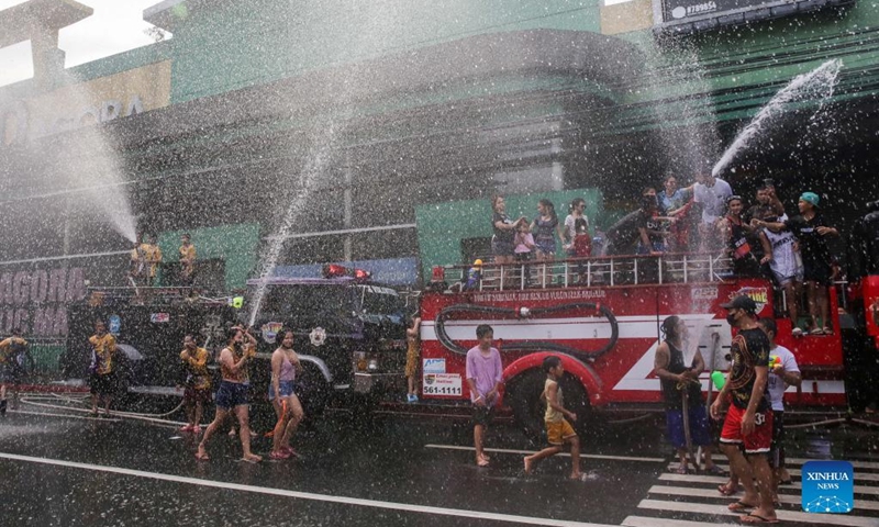 People celebrate the annual Wattah-Wattah Festival in San Juan City, the Philippines, June 24, 2022. The Wattah-Wattah Festival is celebrated with vigorous and boisterous street dancing, basaan (dousing of water), parades and concerts performed by local artists. (Xinhua/Rouelle Umali)