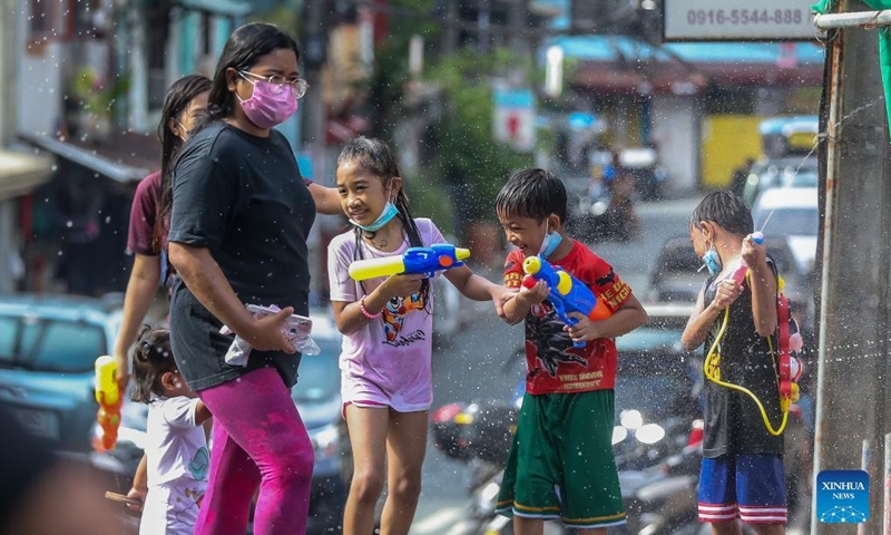 Children play with toy water guns during the annual Wattah-Wattah Festival in San Juan City, the Philippines, June 24, 2022. The Wattah-Wattah Festival is celebrated with vigorous and boisterous street dancing, basaan (dousing of water), parades and concerts performed by local artists. (Xinhua/Rouelle Umali)